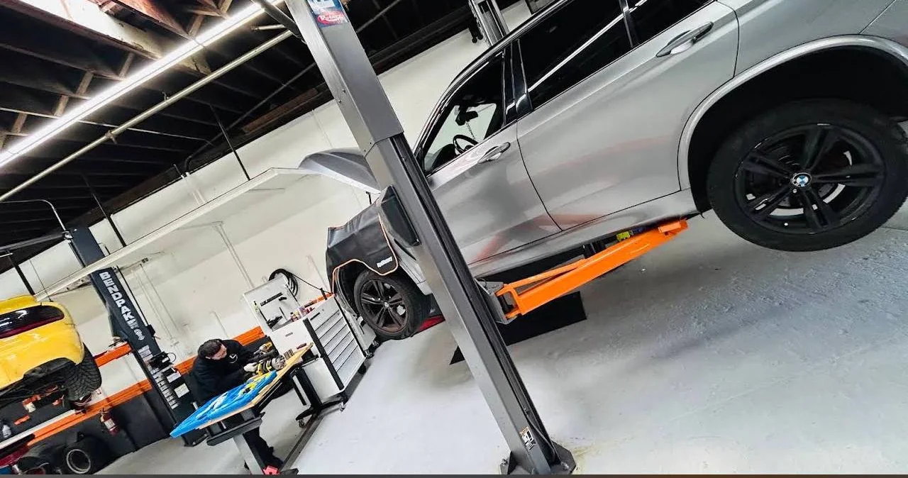 Vehicle raised on a service lift inside Lane Auto